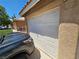 Close-up of the white garage door, matching the home's exterior paint, with a car partially visible at 8072 Cimarron Ridge Dr # 201, Las Vegas, NV 89128