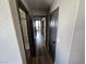 Hallway with hardwood floors leads to bedrooms with dark painted doors at 8072 Cimarron Ridge Dr # 201, Las Vegas, NV 89128