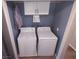 Efficient laundry room equipped with a washer, dryer, and storage, making laundry convenient and organized at 8072 Cimarron Ridge Dr # 201, Las Vegas, NV 89128