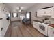 Bright living space with modern decor, wood-look floors, and white kitchen cabinets at 8072 Cimarron Ridge Dr # 201, Las Vegas, NV 89128