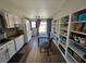 Bright living room boasts custom shelving, adjacent kitchen, and dining area with backyard access at 8072 Cimarron Ridge Dr # 201, Las Vegas, NV 89128