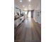 Open living space with wood-look floors, white cabinets, and modern shelving at 8072 Cimarron Ridge Dr # 201, Las Vegas, NV 89128