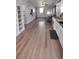 Bright open living space with modern decor, wood-look floors, and white kitchen cabinets at 8072 Cimarron Ridge Dr # 201, Las Vegas, NV 89128