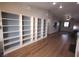 Open-concept living space with custom shelving and modern lighting at 8072 Cimarron Ridge Dr # 201, Las Vegas, NV 89128