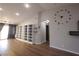 This living room features an open floor plan, wood-look floors, and modern shelving at 8072 Cimarron Ridge Dr # 201, Las Vegas, NV 89128