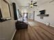 Open living room with a ceiling fan and wood laminate flooring throughout at 8072 Cimarron Ridge Dr # 201, Las Vegas, NV 89128