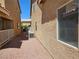 Exterior shot of the side yard with gravel and an air conditioning unit at 8072 Cimarron Ridge Dr # 201, Las Vegas, NV 89128