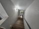 A downward view of the wood stairway leading to the front door at 8072 Cimarron Ridge Dr # 201, Las Vegas, NV 89128