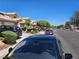 Neighborhood street view with well-maintained townhomes, mature trees, and parked cars at 8072 Cimarron Ridge Dr # 201, Las Vegas, NV 89128