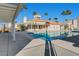Community pool area featuring a pool, spa, and shaded seating areas at 8124 Bay Harbor Dr, Las Vegas, NV 89128