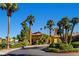 Beautiful building exterior with lush landscaping, palm trees, and a paved road at 8124 Bay Harbor Dr, Las Vegas, NV 89128