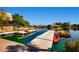 Lakeside community featuring a dock with paddle boats and nearby mature landscaping at 8124 Bay Harbor Dr, Las Vegas, NV 89128