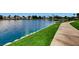 Scenic lake view with a walking path next to the water and houses in the background at 8124 Bay Harbor Dr, Las Vegas, NV 89128
