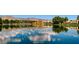 Scenic community lake reflecting the blue sky and architecture beyond with lush trees and landscaping at 8124 Bay Harbor Dr, Las Vegas, NV 89128