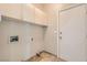 Clean, functional laundry room with overhead storage and access to the outdoors at 8124 Bay Harbor Dr, Las Vegas, NV 89128