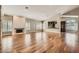 Large living area with wood flooring, a fireplace, a bar area, and plantation shutters at 8124 Bay Harbor Dr, Las Vegas, NV 89128
