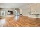 Spacious living room featuring wood floors, a fireplace, a bar area, and abundant natural light from the windows at 8124 Bay Harbor Dr, Las Vegas, NV 89128