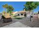 This home boasts a covered patio, low maintenance landscaping, and mature trees at 832 Seco Verde Ave, Henderson, NV 89015