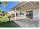 Enjoy the covered patio, lawn, and sliding glass doors leading inside at 832 Seco Verde Ave, Henderson, NV 89015