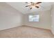 Spacious carpeted bedroom features a window and ceiling fan at 832 Seco Verde Ave, Henderson, NV 89015