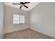 Bright bedroom featuring a window, ceiling fan, and neutral carpeting for a cozy feel at 832 Seco Verde Ave, Henderson, NV 89015