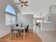 Bright dining room with wood floors, square table with seating, and a large arched window letting in lots of light at 832 Seco Verde Ave, Henderson, NV 89015