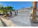 Single-story home featuring mature landscaping, covered entry and desert landscaping at 832 Seco Verde Ave, Henderson, NV 89015