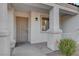 Close-up of a front porch featuring a security door and desert landscaping at 832 Seco Verde Ave, Henderson, NV 89015