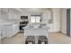 Bright kitchen features white cabinets, stainless appliances, and center island with seating at 832 Seco Verde Ave, Henderson, NV 89015