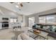 Open kitchen with stainless steel appliances, tile flooring, island with breakfast bar, and sliding doors to backyard at 832 Seco Verde Ave, Henderson, NV 89015