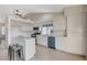 Bright kitchen features white cabinets, stainless appliances, and center island with seating at 832 Seco Verde Ave, Henderson, NV 89015