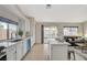 Open concept kitchen with white cabinets, stainless appliances and a view to the living room at 832 Seco Verde Ave, Henderson, NV 89015