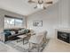 Comfortable living room with tile flooring, ceiling fan, grey sofa with decorative pillows, and fireplace at 832 Seco Verde Ave, Henderson, NV 89015