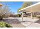 Expansive backyard featuring a covered patio, mature trees, and ample space for outdoor activities at 8337 Willow Basin Ct, Las Vegas, NV 89131