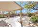 A backyard view with a covered patio, decorative walkway, and landscaping at 8337 Willow Basin Ct, Las Vegas, NV 89131