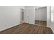 Sun-filled bedroom featuring wood-look floors and a mirrored closet at 8337 Willow Basin Ct, Las Vegas, NV 89131