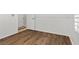 Bright bedroom featuring wood-look floors, white walls, and a white door at 8337 Willow Basin Ct, Las Vegas, NV 89131
