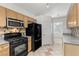 Functional kitchen featuring modern appliances, tile backsplash, granite countertops, and plenty of natural light at 8337 Willow Basin Ct, Las Vegas, NV 89131