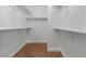 Walk-in closet featuring built-in shelving and wood-look floors at 8337 Willow Basin Ct, Las Vegas, NV 89131