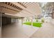 Large backyard featuring a covered patio, gravel landscaping, and artificial turf at 8757 Beluga Way, Las Vegas, NV 89117