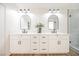 Contemporary bathroom featuring double sinks, modern lighting, and a glass-enclosed shower at 8757 Beluga Way, Las Vegas, NV 89117