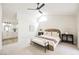 Inviting bedroom featuring vaulted ceilings, a ceiling fan, and access to the ensuite bathroom at 8757 Beluga Way, Las Vegas, NV 89117