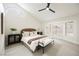 Comfortable bedroom with vaulted ceilings, a ceiling fan, and a large window offering natural light at 8757 Beluga Way, Las Vegas, NV 89117