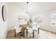 Well-lit dining room with modern furniture, a wooden table, and natural light from the windows at 8757 Beluga Way, Las Vegas, NV 89117