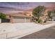 Charming single-story home with a three-car garage, mature landscaping, and a tile roof at 8757 Beluga Way, Las Vegas, NV 89117