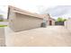 Exterior view of home shows a large concrete driveway and side entrance at 8757 Beluga Way, Las Vegas, NV 89117