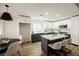 Bright eat-in kitchen features a center island with barstool seating, stainless steel appliances, and stylish pendant lights at 8757 Beluga Way, Las Vegas, NV 89117