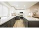 Modern kitchen with bright white cabinets, gray island, stainless steel appliances, and updated countertops at 8757 Beluga Way, Las Vegas, NV 89117