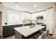 Updated kitchen featuring a center island, white cabinetry, stainless steel appliances, and stylish bar stool seating at 8757 Beluga Way, Las Vegas, NV 89117