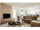 Bright living room featuring a fireplace, modern furniture, and sliding door access to the outdoors at 8757 Beluga Way, Las Vegas, NV 89117